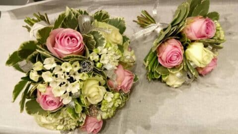 Bouquets pour demoiselles d’honneur – Roses roses Duo de bouquets pour demoiselles d'honneur avec roses roses, fleurs blanches et ruban argenté, fleuriste mariage Openflor.
